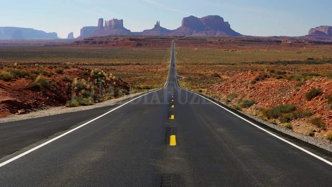 Stock Video - Upwards pan of highway 163 from Forrest Gump Point towards Monument Valley