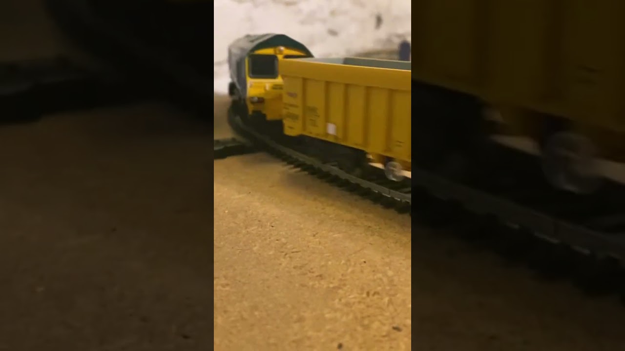 Freightliner 66623 passes signal box on engineering train