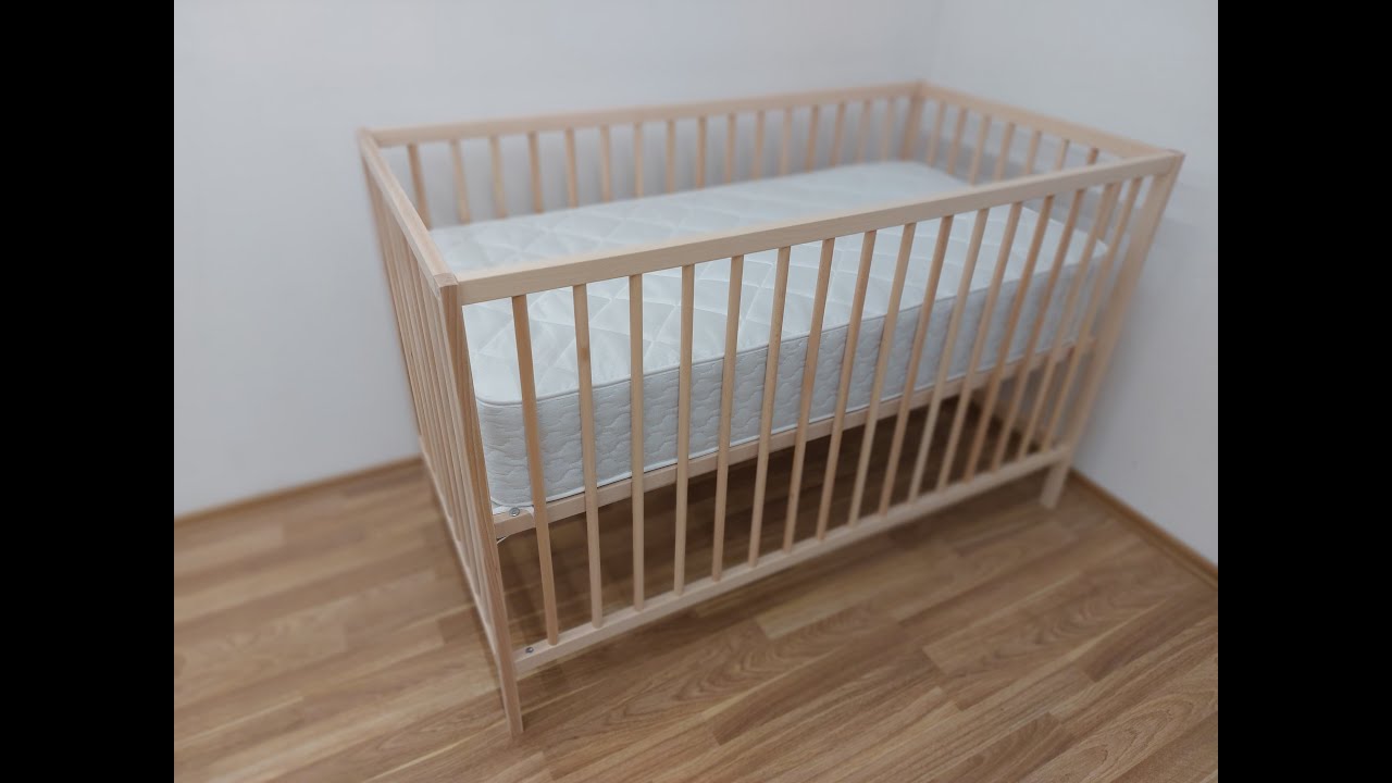 Assembling an IKEA baby bed.