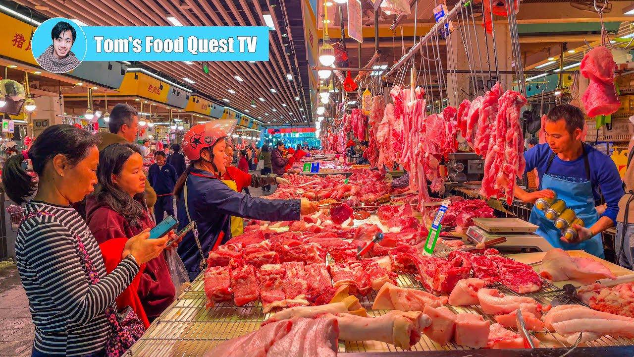 Large morning market in Shenzhen, China: fresh vegetables and meat, busy morning