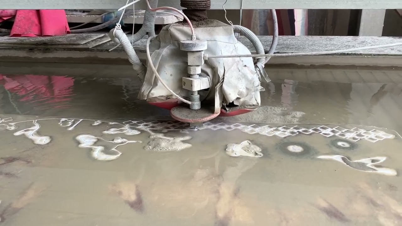 CNC waterjet machine cutting marble to make marble medallion