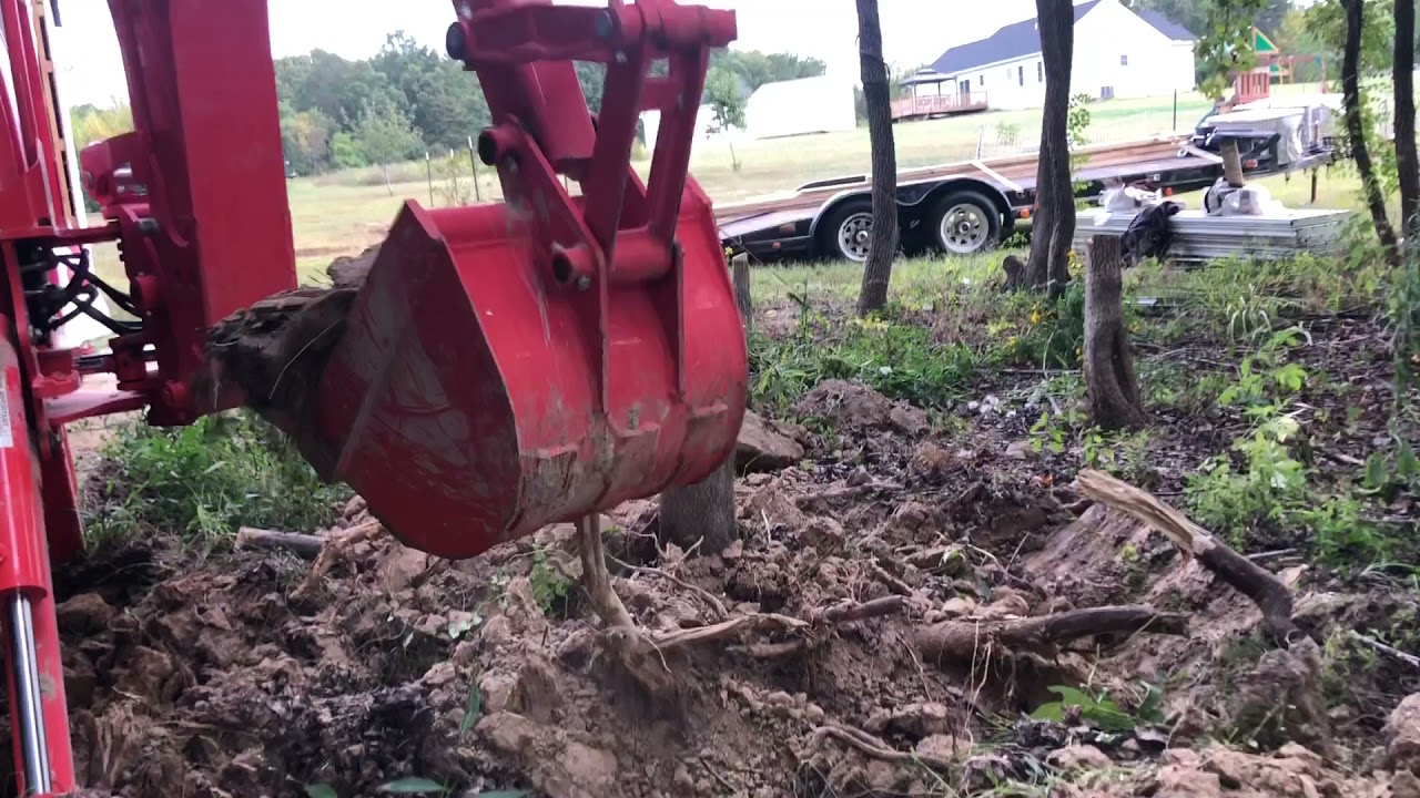 3- Kubota LX2610 DIGGING OUT STUMPS WITH THE BH77 BACKHOE.