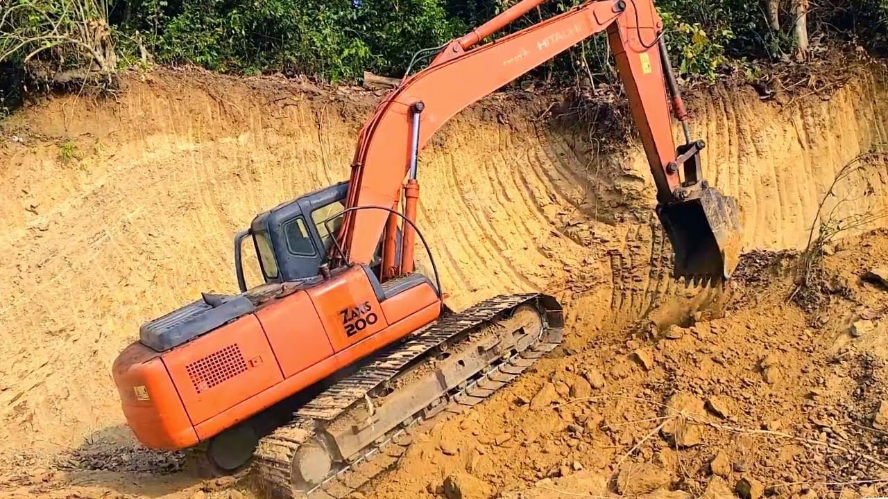 Excavator Cutting Slope and Digging Loading Dirt Into Dump Trucks
