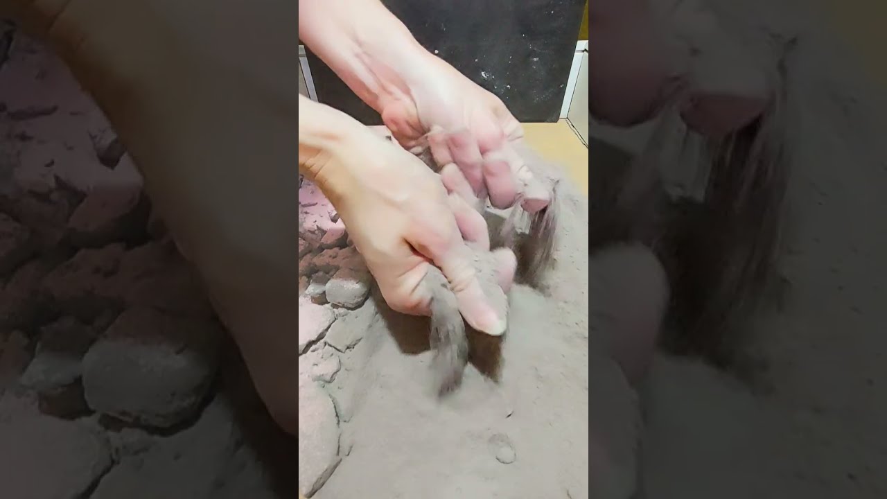 Pebbles with pink gymchalk, dusty crushing and sifting, brush sweeping, side view