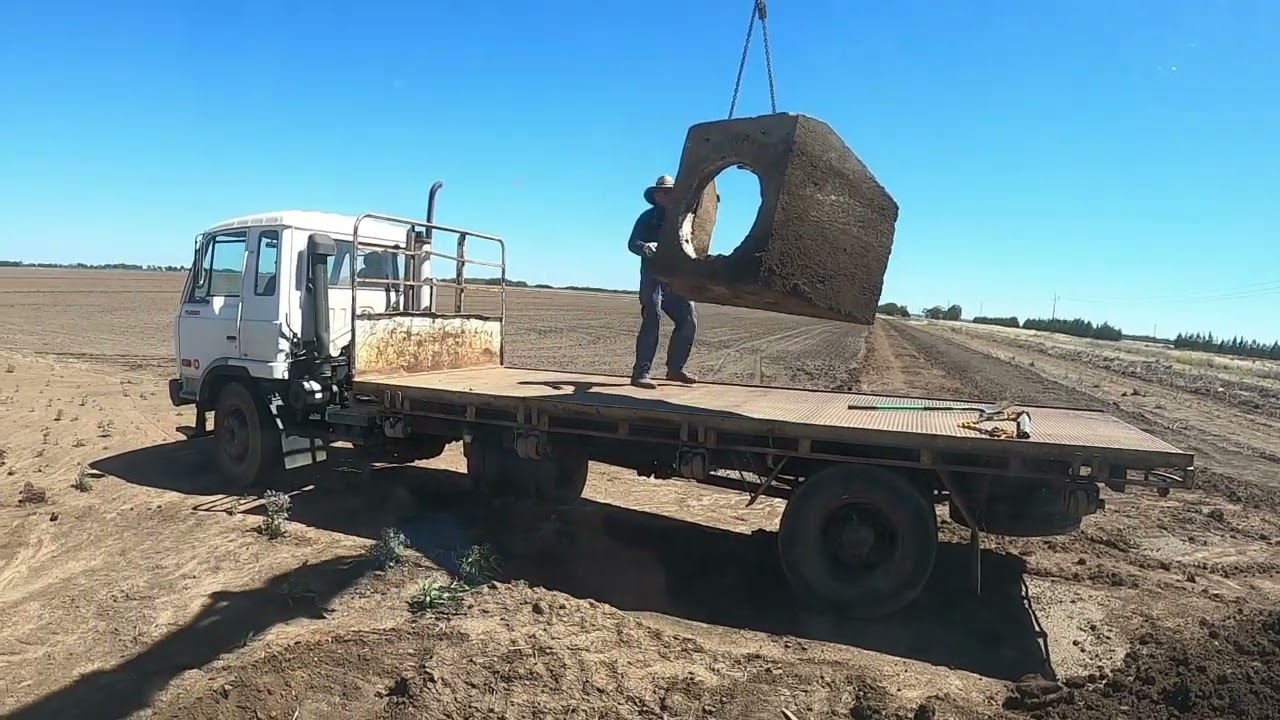 Excavator removing irrigation structures