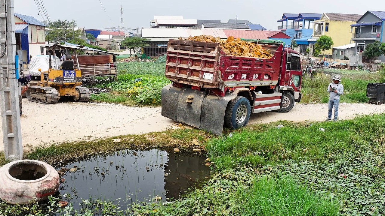 wonderful nice full project landfill , truck transport soil stone , bulldozer push soil to water