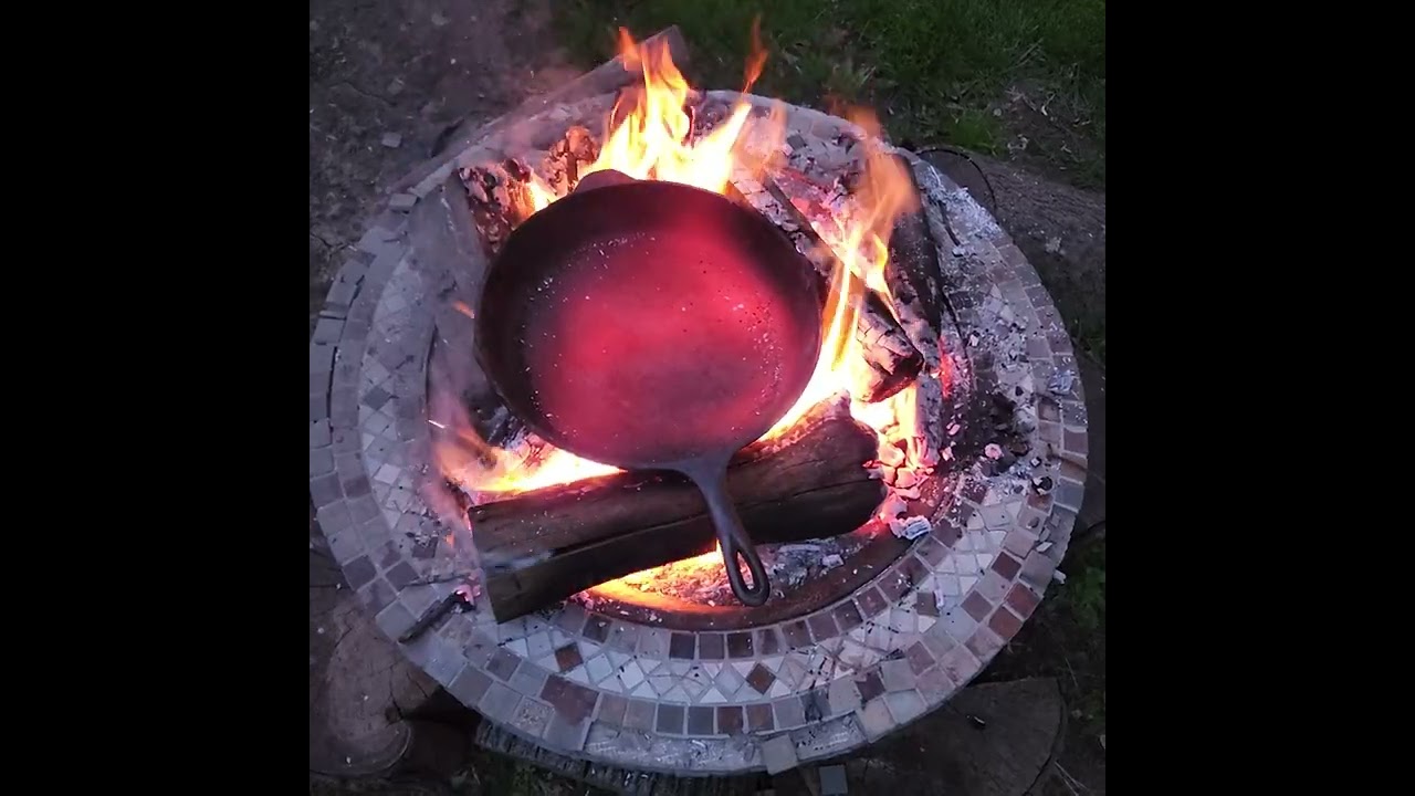 Getting the cast iron ready for seasoning on a open fire 🔥