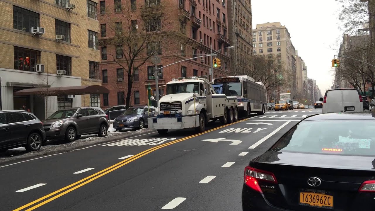 GIANT MTA CENTURY 9055 50 TON WRECKER TOWING NYC MTA BUS ON WEST END AVE. ON WEST SIDE OF MANHATTAN.