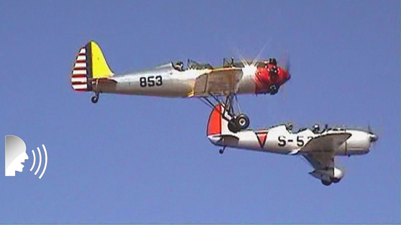 Vintage monoplane and biplane fly-by