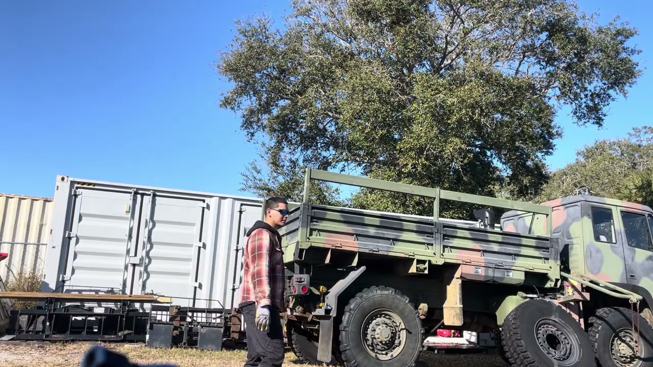Lmtv M1078 military truck swapping out a tire 