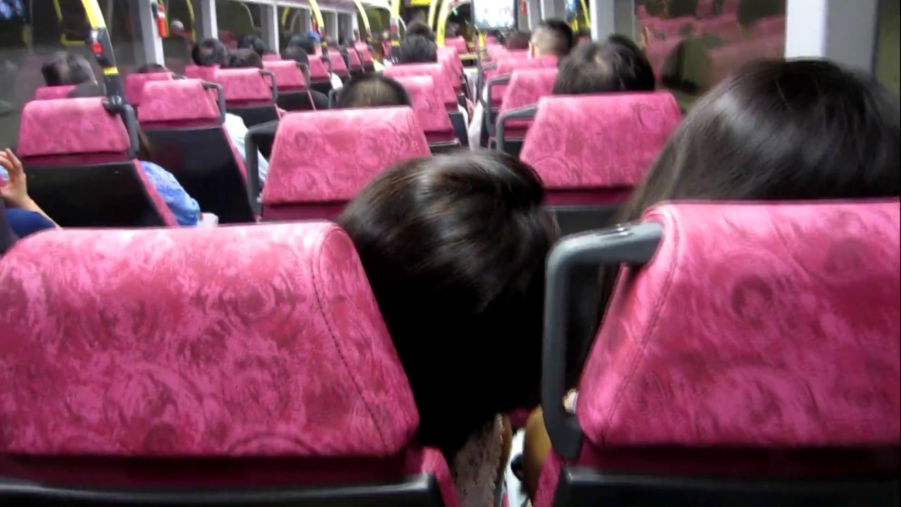 Woman trying to sleep on Hong Kong bus