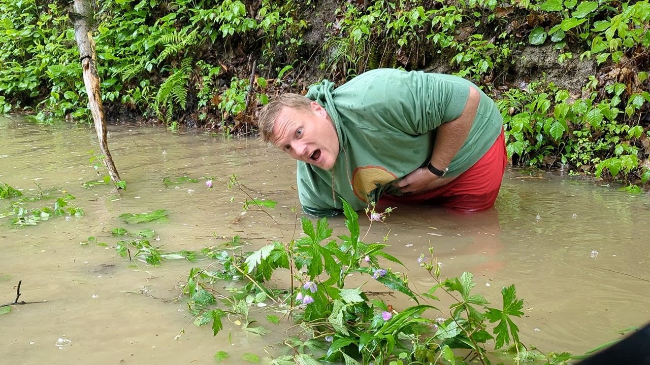 Unclogging a rural culvert.
