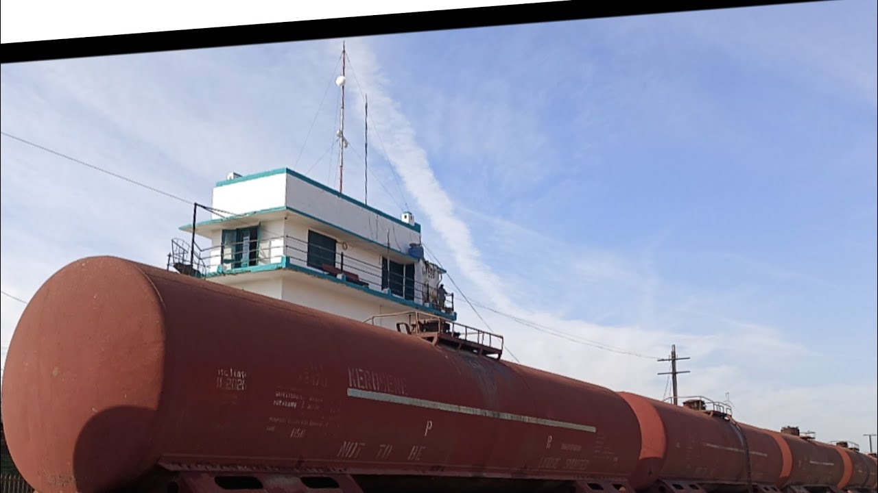 Two goods trains at Rawalpindi Yard — one oil tanker and one covered wagon.