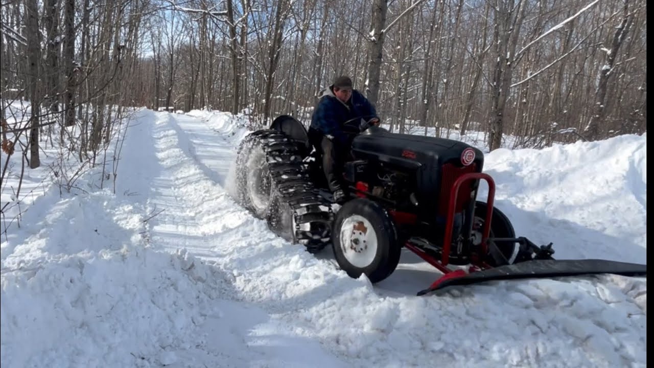 Half track tractor plowing snow
