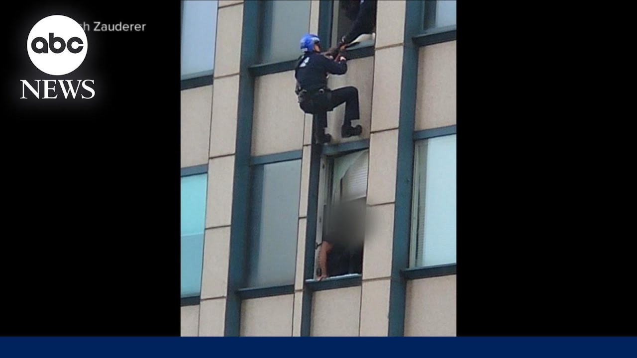 Man dangles from NYC skyscraper in FBI standoff