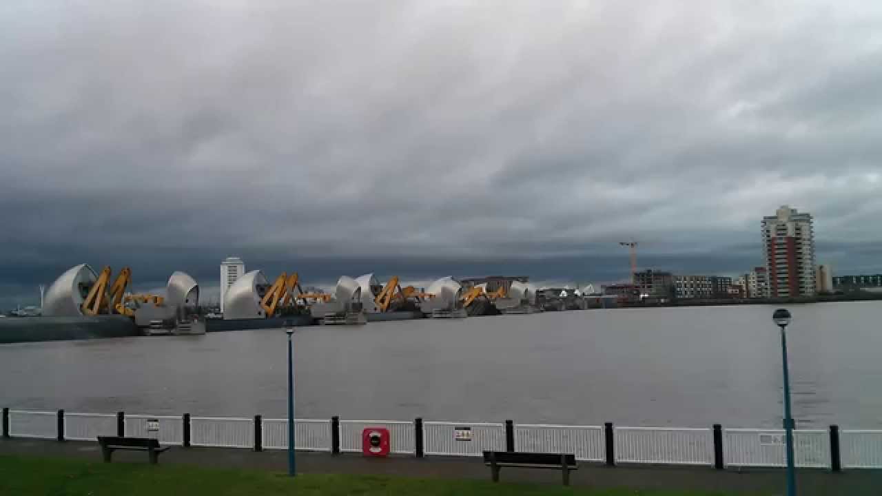 Thames Barrier closing in time lapse, and water flows into park.