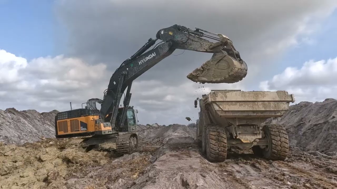 Hyundai HX1000AL loading trucks at sand pit.