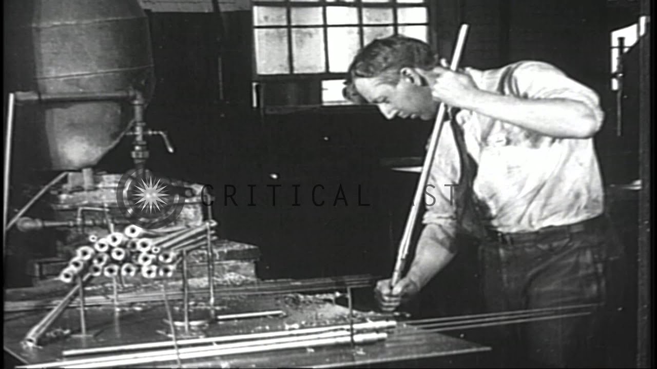 Men work at machinery in a rifle manufacturing factory in the United States durin...HD Stock Footage