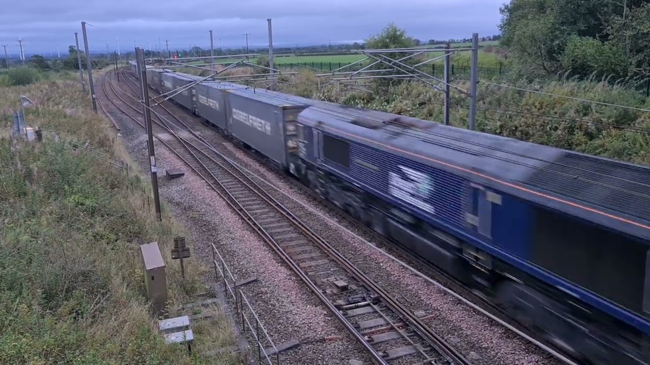 Class 66 passes Quintinshill Loops with a late running container train, 5-9-24.