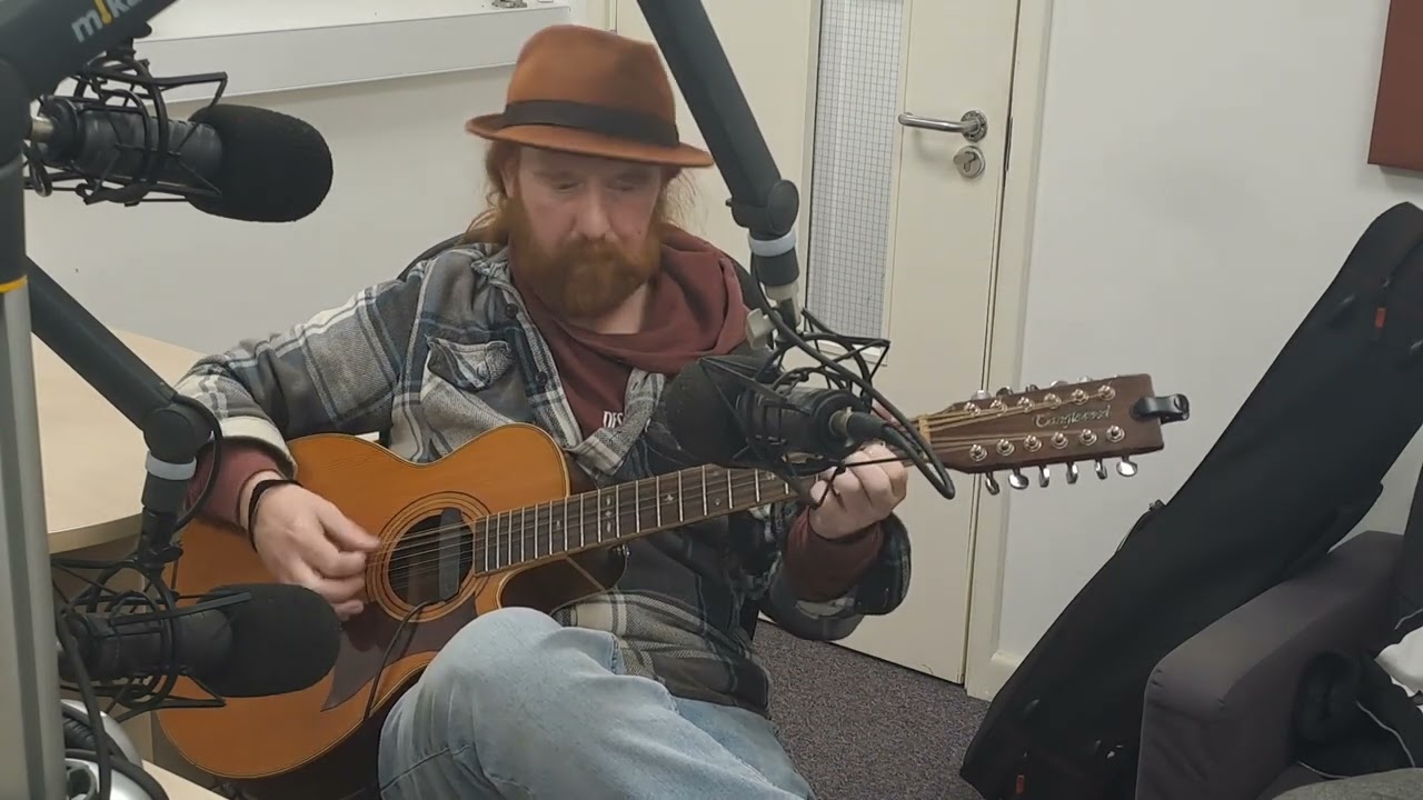 Rab McIlraith jamming out in the the studio on 90.1 HopeFM LiveWire Live, around a song by Caius