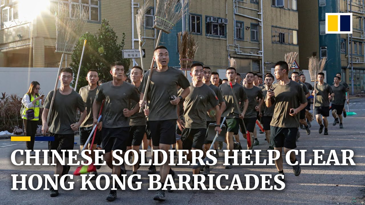 Chinese soldiers and residents help clear streets after a week of intense protest in Hong Kong