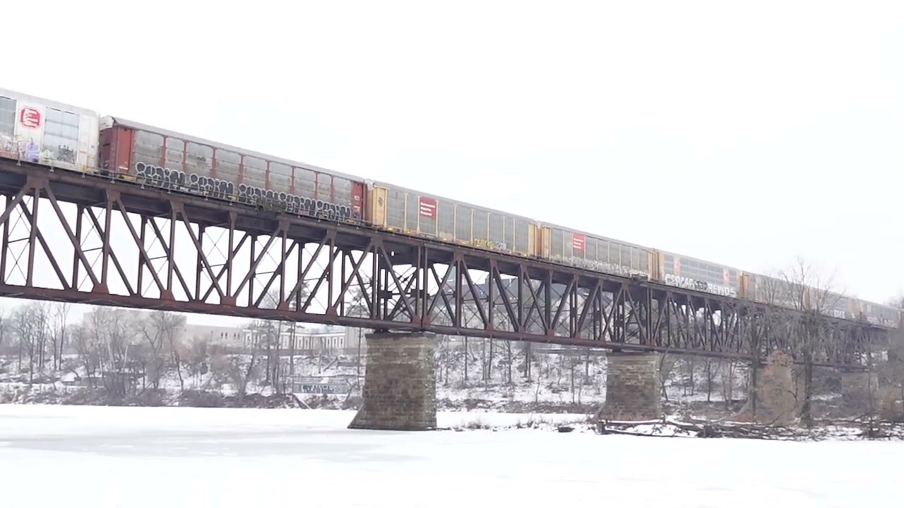 CPKC 137 with BNSF H2 unit going over the trestle bridge on the Galt sub