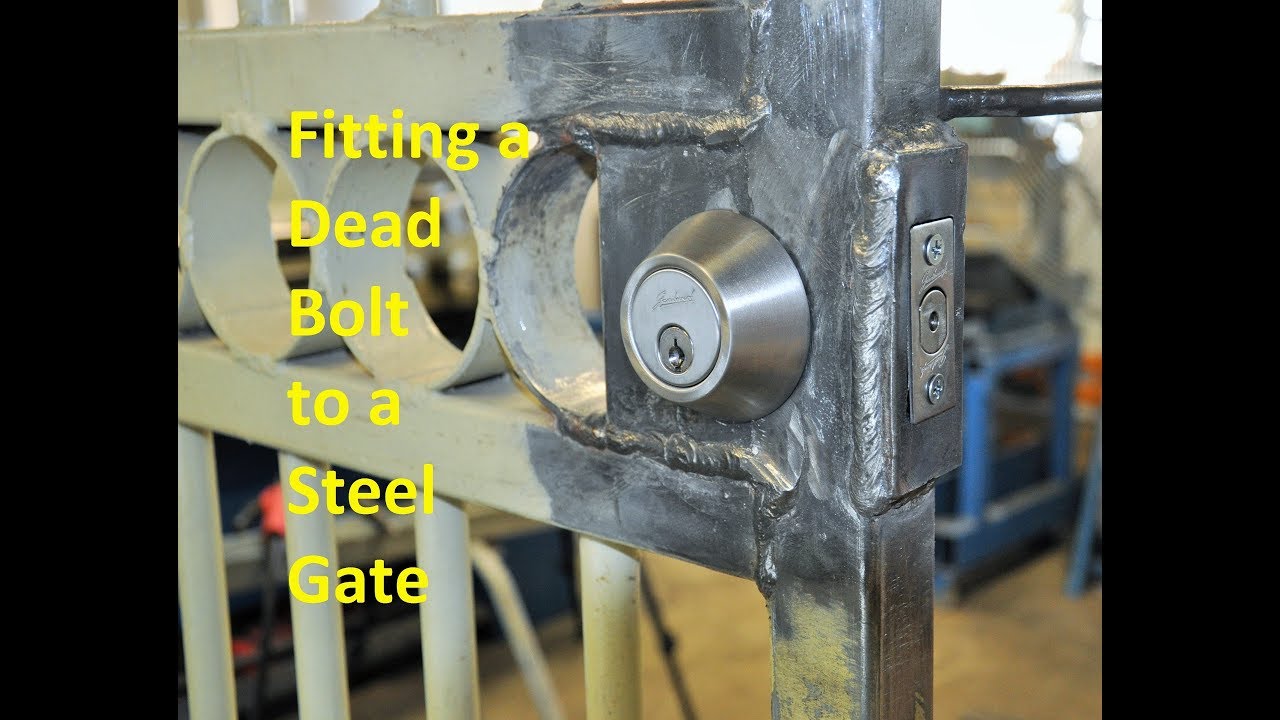Fitting a dead bolt to a steel gate.
