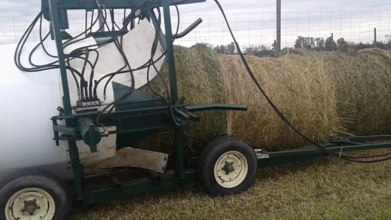 Silage bales loaded into tube-o-lator plastic bag