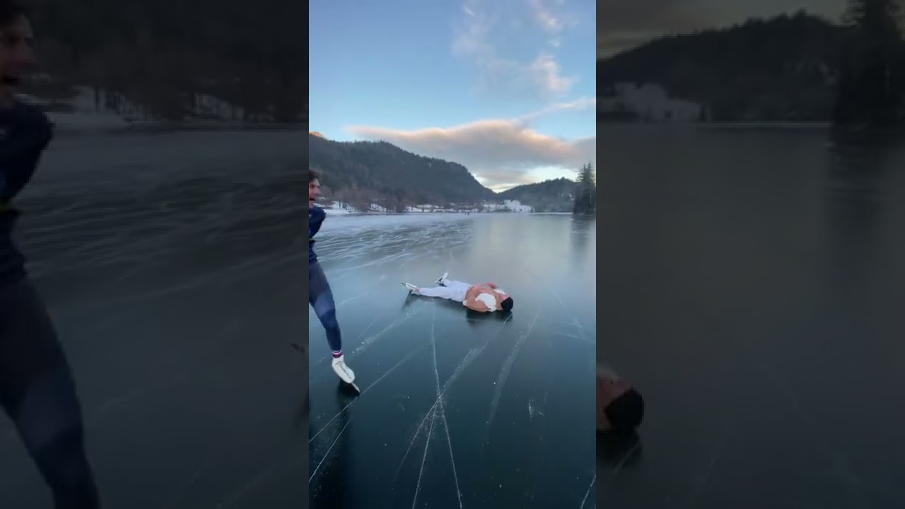 Guy wipes out while ice skating on a frozen lake!