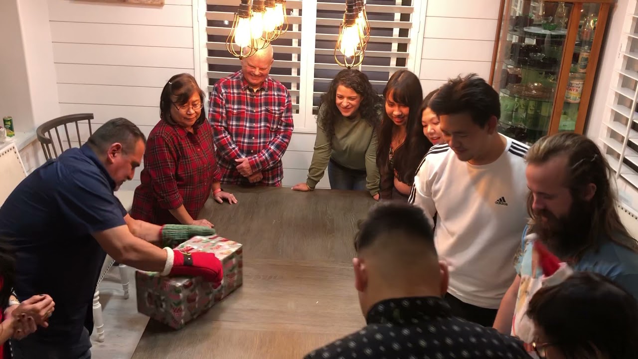 Unwrap a Christmas Gift game with oven mitt fun fun fun 2021 Family & Friends Christmas Party