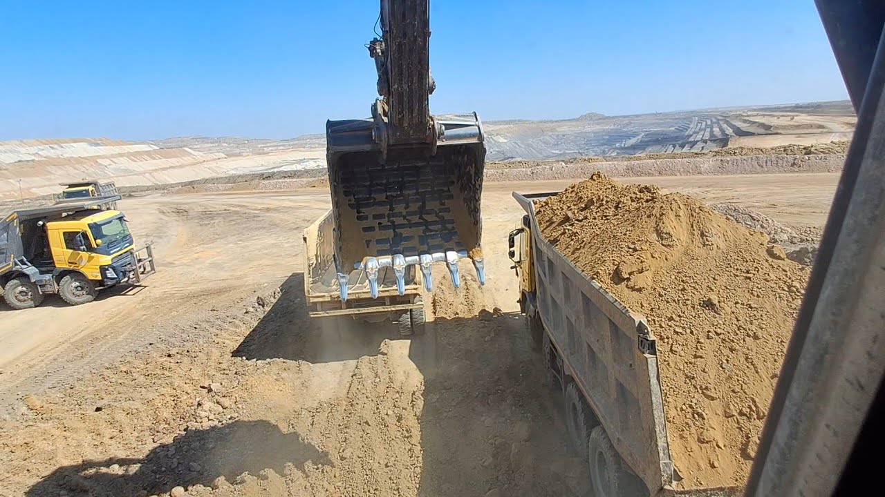 digging a pond with an excavatordigging with skid steerloading dump trucks with excavatorexcavator