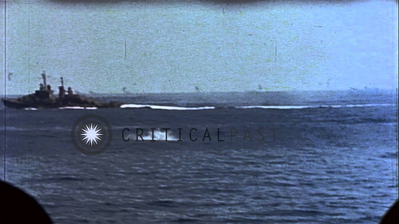 Destroyer and battleship fire antiaircraft guns underway at sea, Pacific Ocean. HD Stock Footage