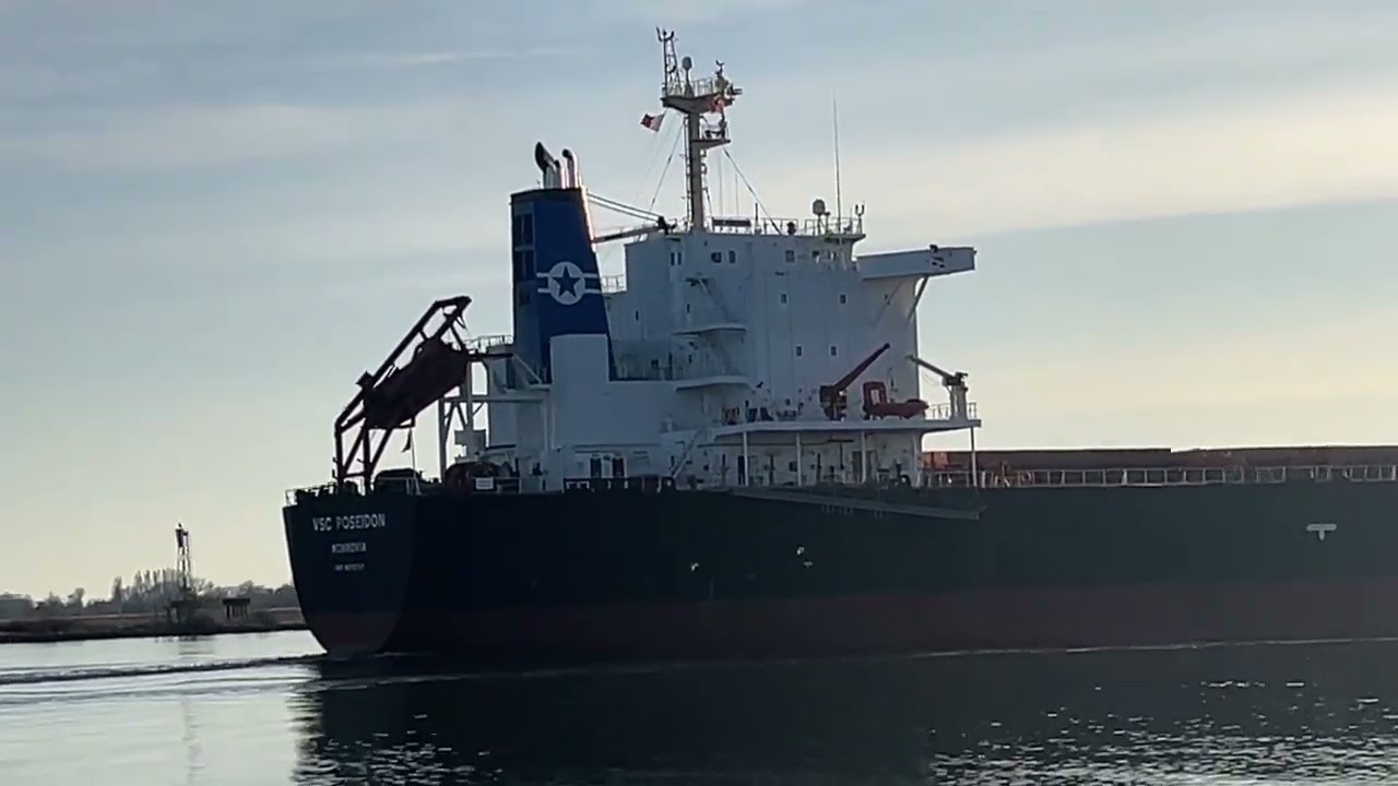 Two Cargo Ships Passing Close-Up