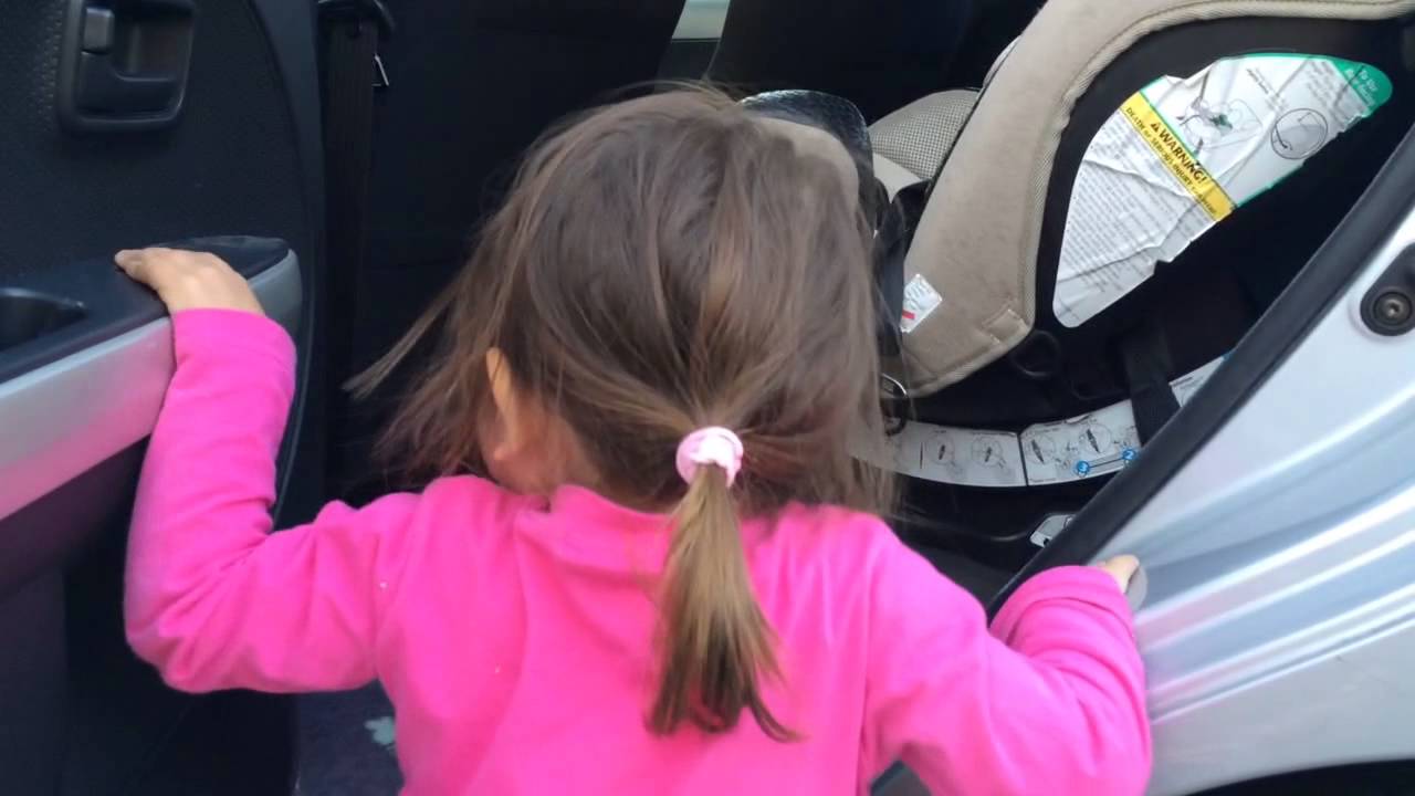 Yuki gets in her car seat