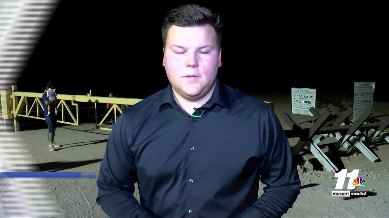 Migrants walk across the border into Yuma