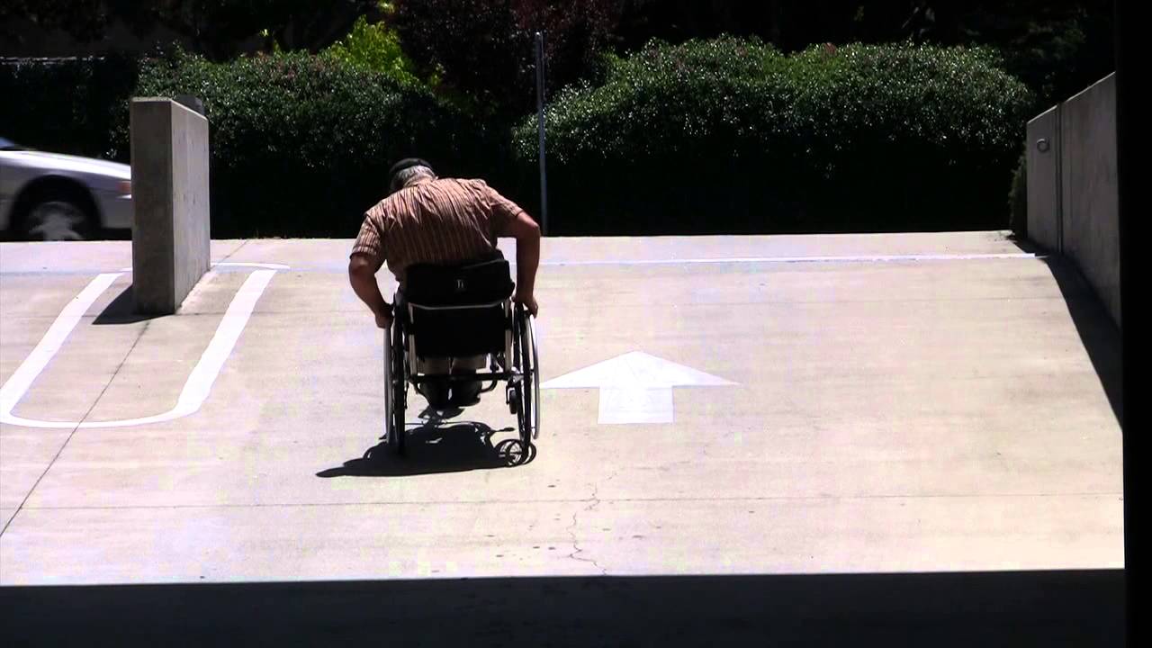 Rio Mobility Dragonfly attachable hand cycle exiting on a steep ramp
