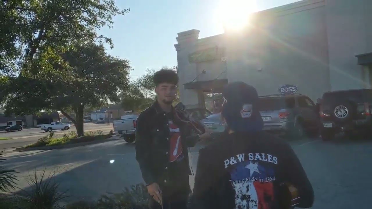 Man pretending to play violin confronted by citizen