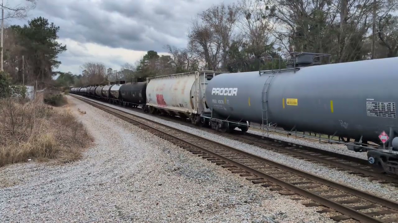 CSX 4547 and CSX 5253 lead a good sized nb mixed freight across Johnson Street in Hope Mills, N.C.