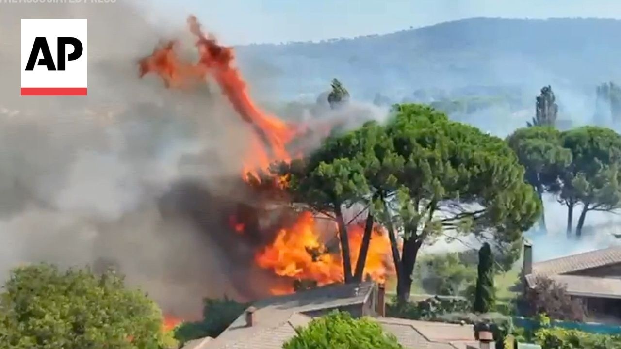 Aerial video shows a wildfire approaching homes in Spain