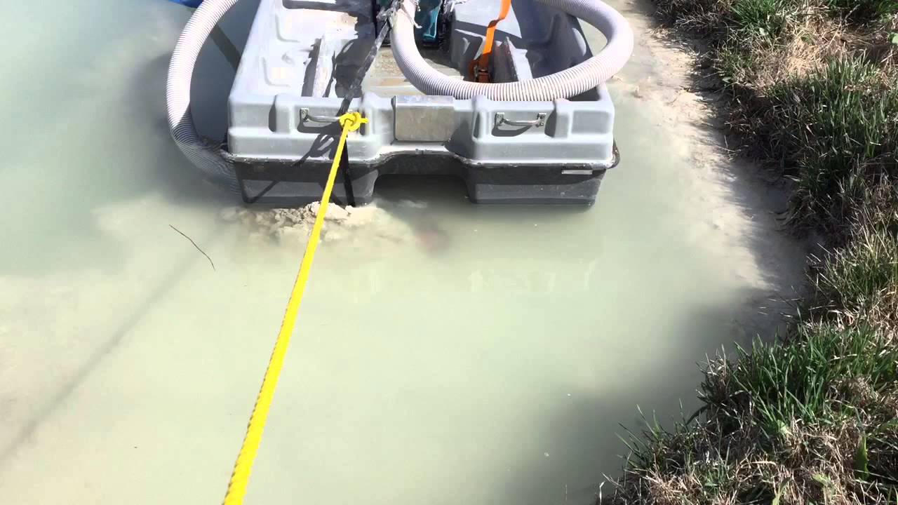 Dredging cement silt out of the stormwater pit.