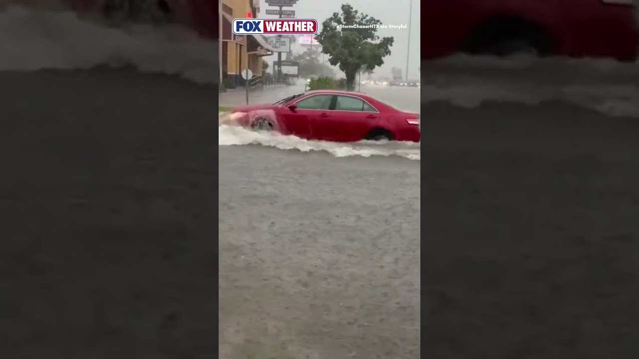 Cars Navigate Through Floodwaters In Texas