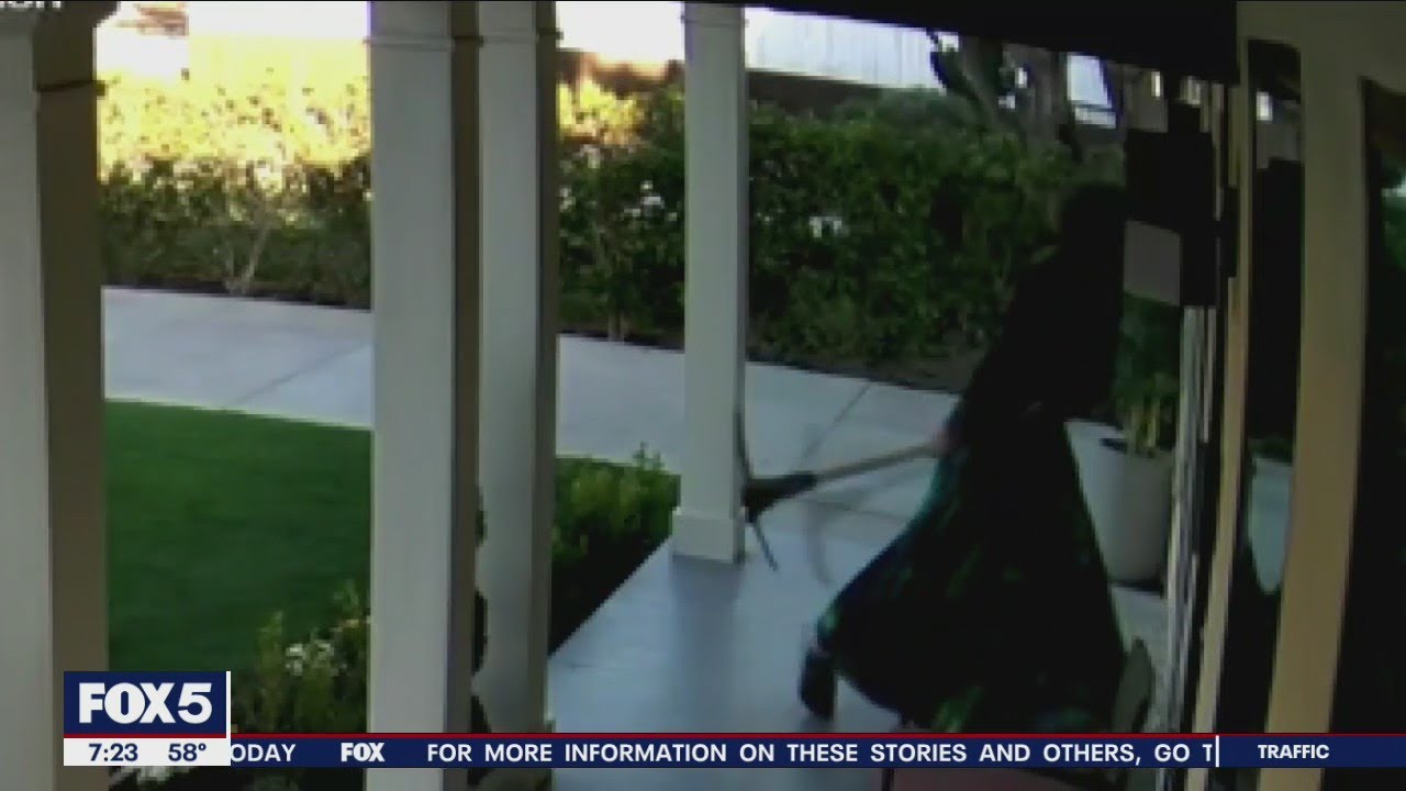 Shocking video:  Woman attacks neighbor's house with pickaxe