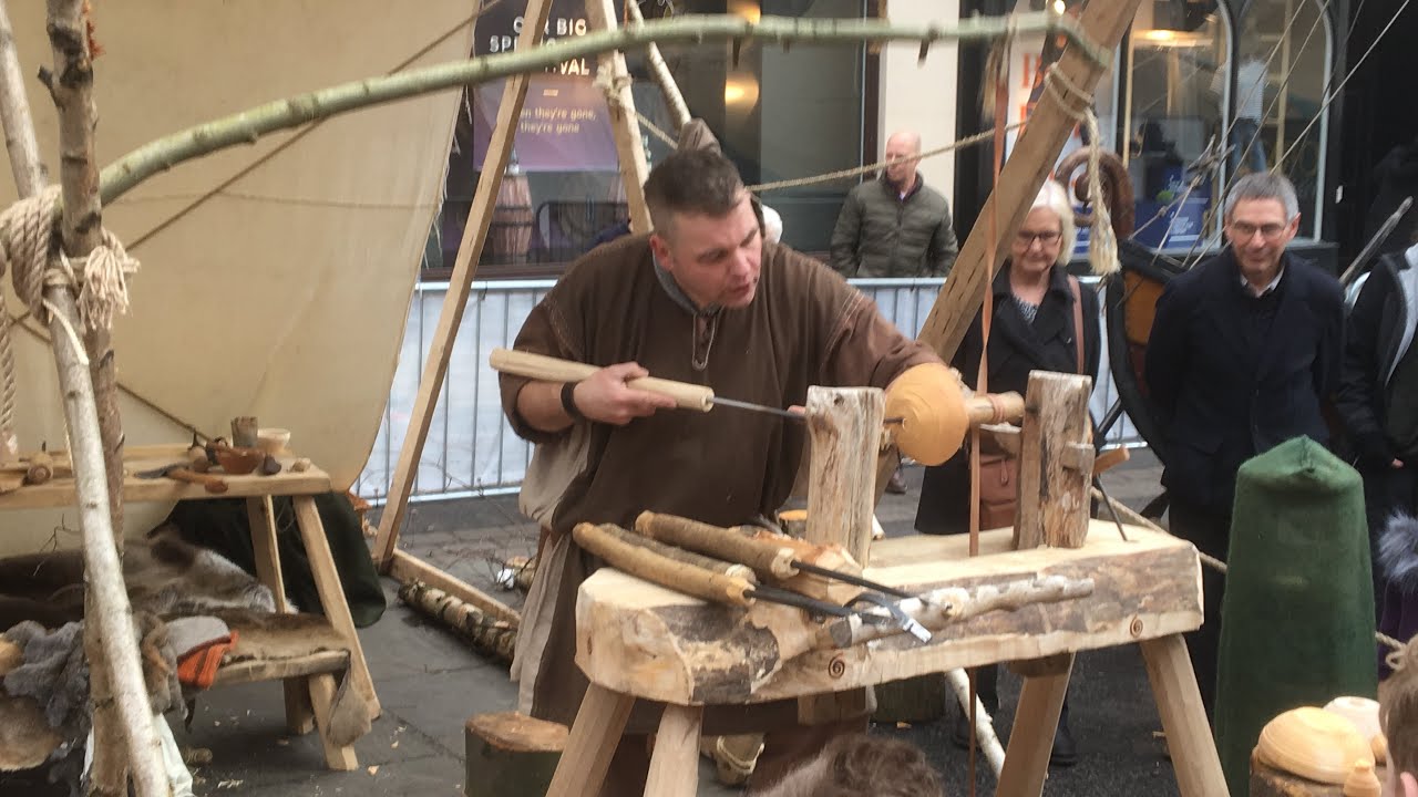 Jorvik, York Viking Festival February 2019. Viking Woodworker shapes a wooden bowl on a pole lathe
