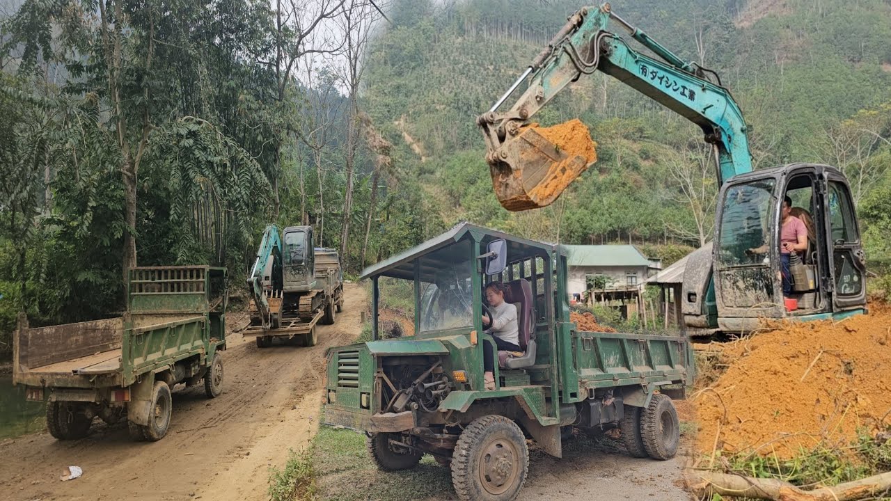 The girl continues to transport soil to build the foundation for the people
