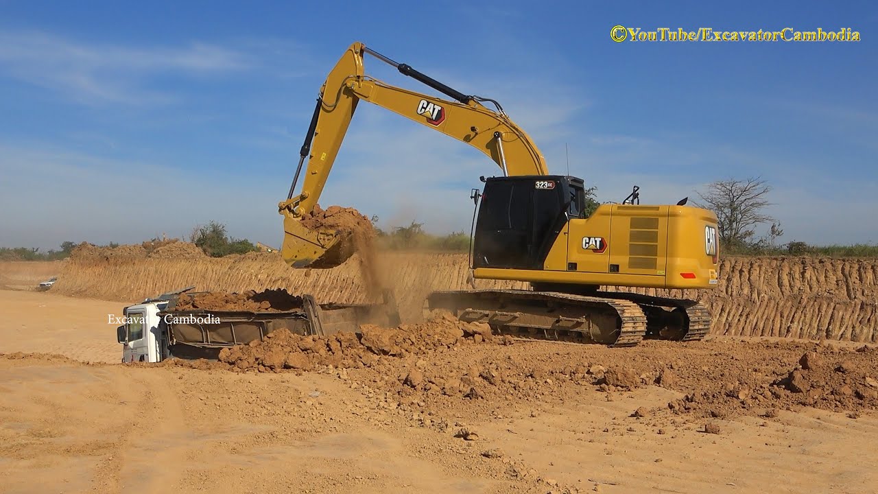 Caterpillar 323 GC Excavator Digging Loading Dump Trucks.