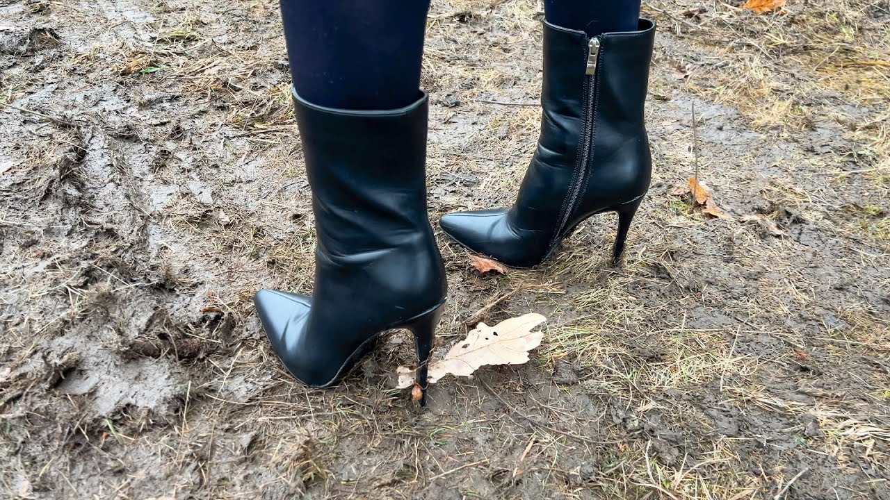 Ellie walks in high heels on wet ground. Sinking heels