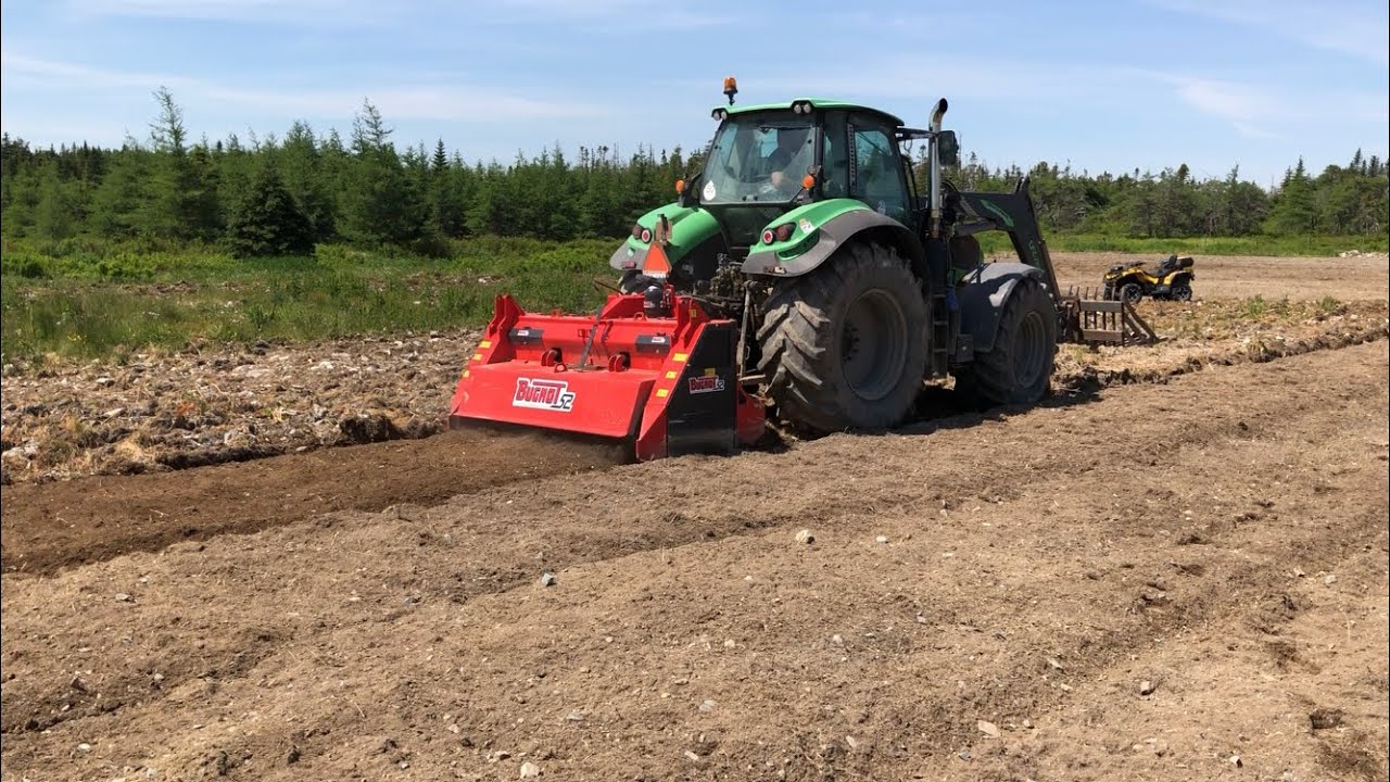 Clearing rocky farm land in Newfoundland - Bugnot rock crusher in action