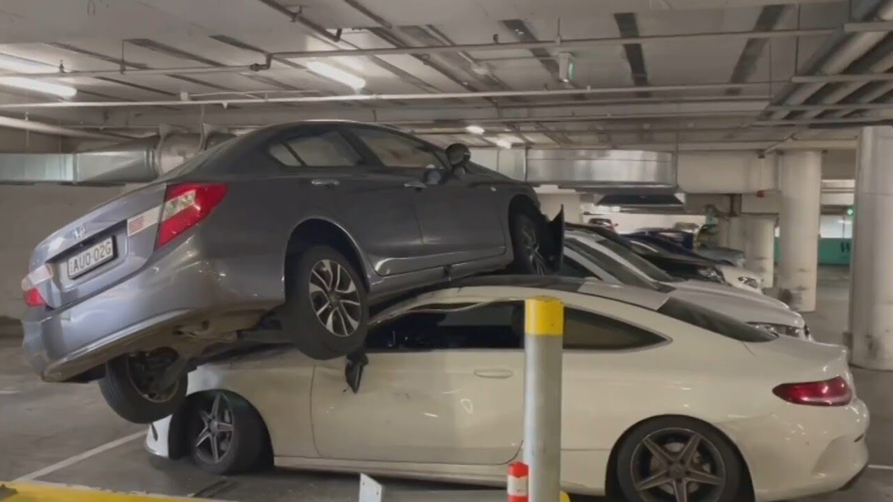 73-year-old woman accidentally drives on top of a parked car in Sydney