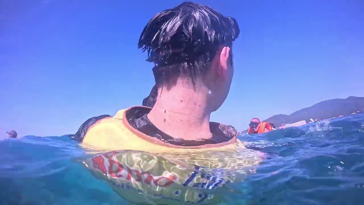 Friends going swimming in Nha Trang in the summer.