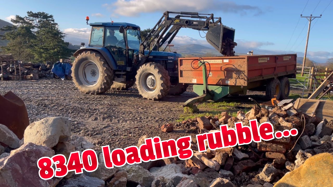 New Holland 8340 with Trimma loader Loading Rubble.